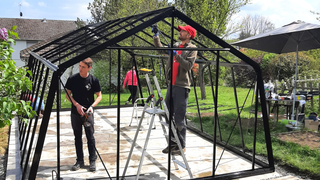 Myfood teams installing a greenhouse at a pioneer